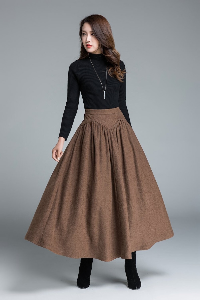 May include: A brown high-waisted skirt with a pleated design.