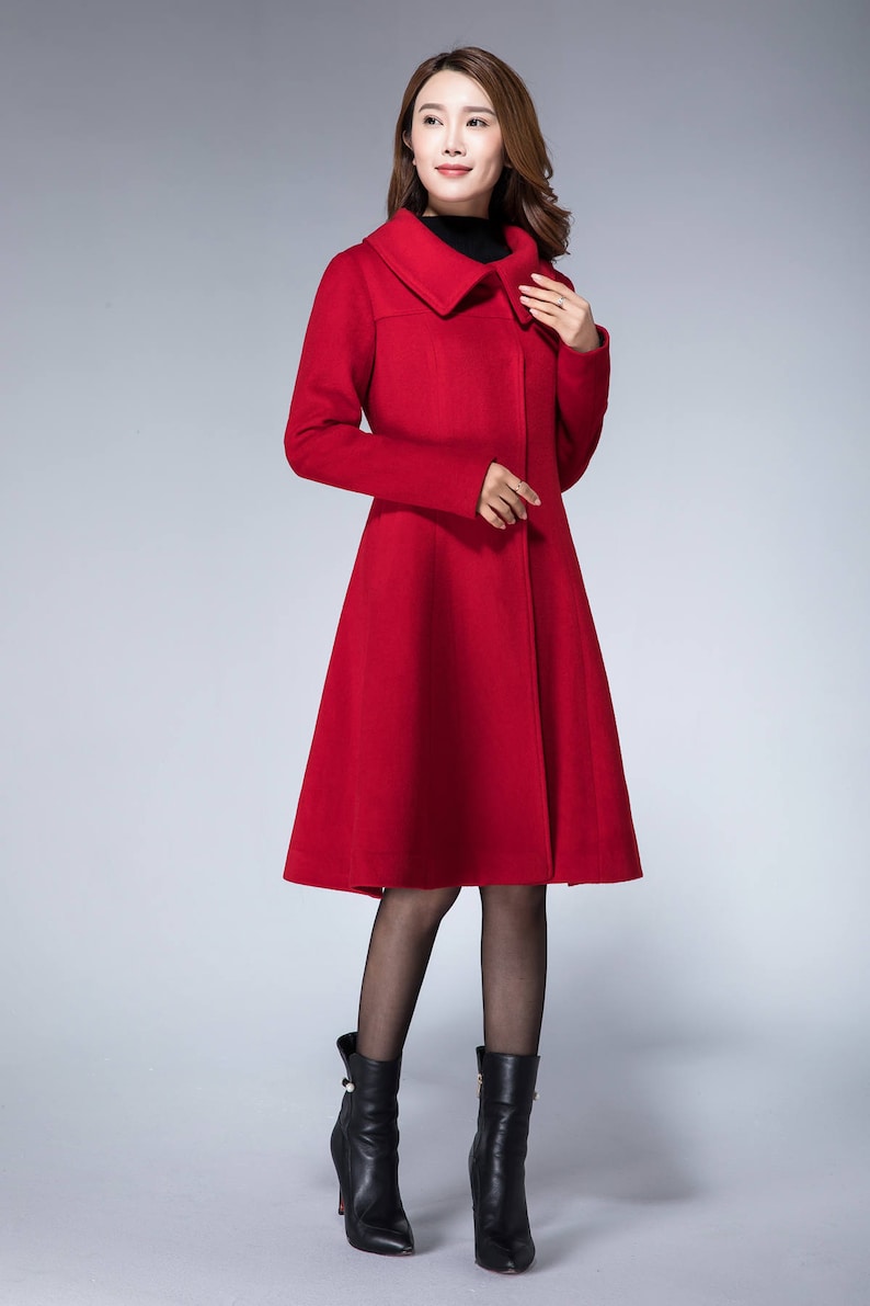 May include: A red wool coat with a wide collar and a flared skirt. The coat is knee-length and has a single button closure.