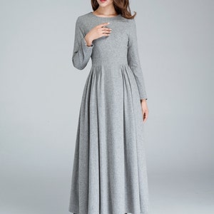 May include: A long-sleeved gray dress with a round neckline and a gathered skirt.
