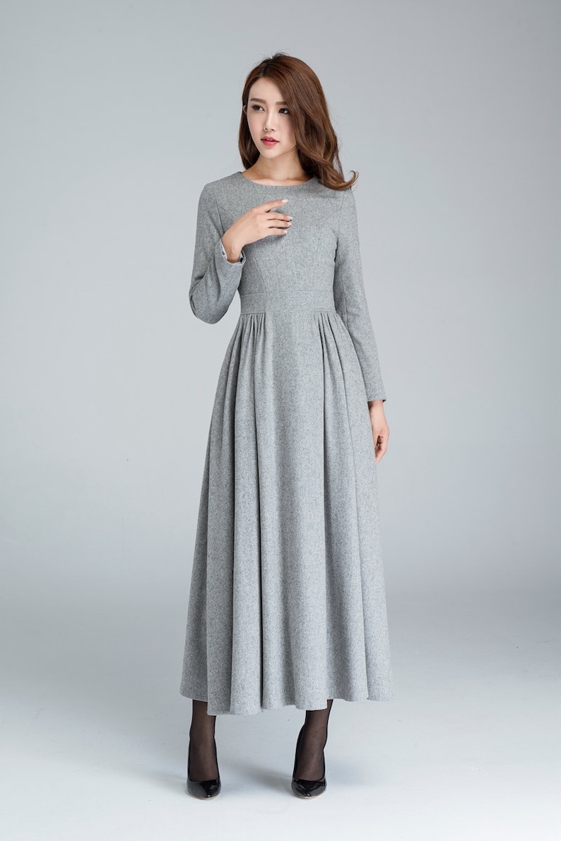 May include: A long-sleeved gray dress with a round neckline and a gathered skirt.