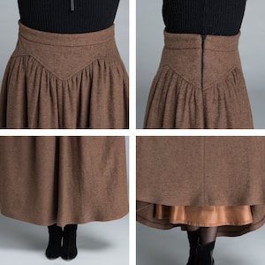 May include: A brown wool skirt with a high waist and a gathered front. The skirt has a hidden zipper in the back and a brown satin lining.