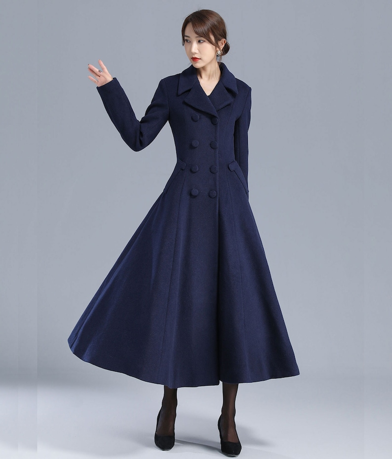 May include: A long, navy blue coat with a double-breasted closure and a flared skirt.