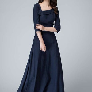May include: A navy blue maxi dress with a square neckline and three-quarter sleeves. The dress has a fitted bodice and a flowing skirt.