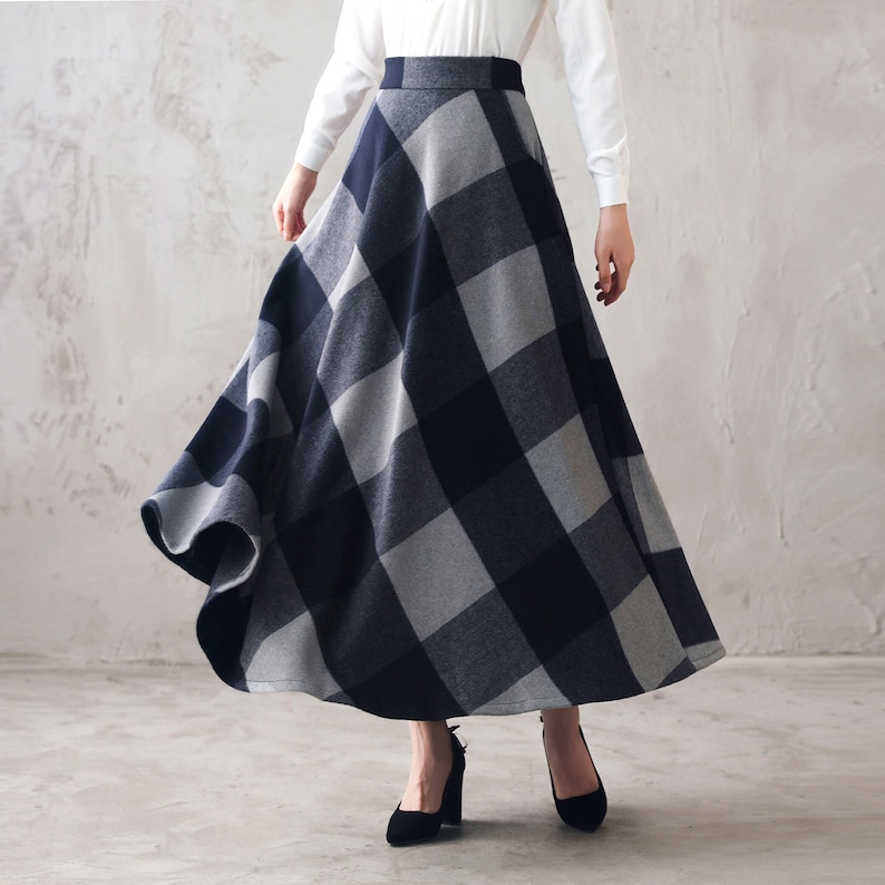 May include: A long, flowing skirt with a black and gray plaid pattern. The skirt is made of a soft, comfortable fabric and has a high waist.