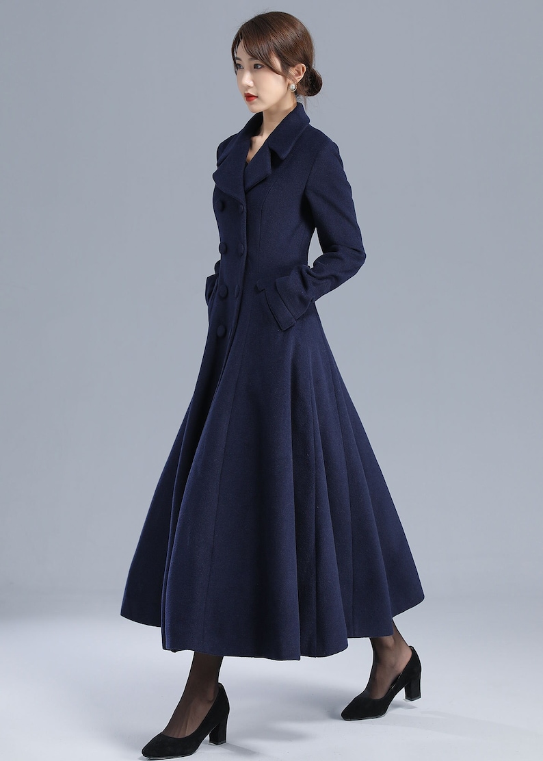 May include: A long, navy blue coat with a double-breasted closure and a flared skirt.