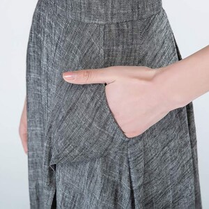 May include: A gray linen dress with a pocket on the side.