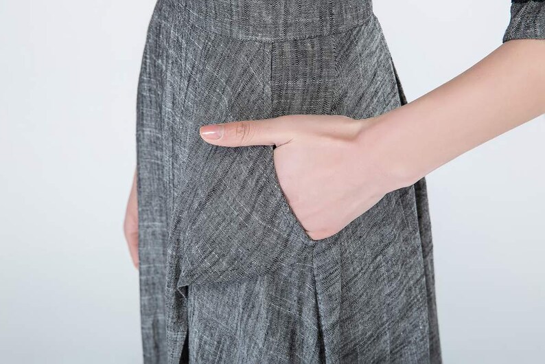 May include: A gray linen dress with a pocket on the side.