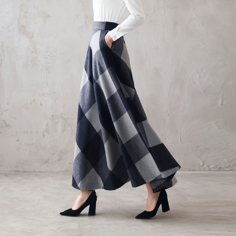 May include: A long, flowing skirt with a black and gray plaid pattern. The skirt is made of a soft, comfortable fabric and has a flattering A-line silhouette.