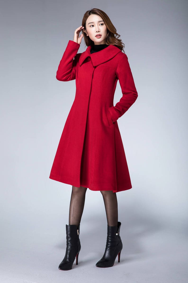 May include: A red wool coat with a wide collar and a flared skirt. The coat is knee-length and has a single button closure.