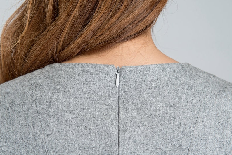May include: Back view of a gray dress with a zipper closure.