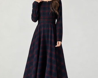 May include: A long-sleeved midi dress featuring a dark navy blue and deep red plaid pattern. The garment has a round neckline, a fitted bodice with a defined waistline, and a flared, A-line skirt that falls below the knees in a structured silhouette.