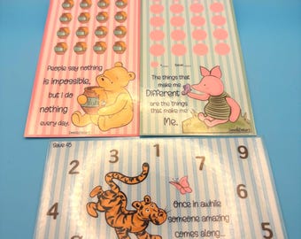 May include: Three colorful cards featuring Winnie the Pooh characters. One card has Winnie the Pooh with text, another has Piglet, and the third has Tigger. Each card has a unique design with stripes, dots, and numbers.
