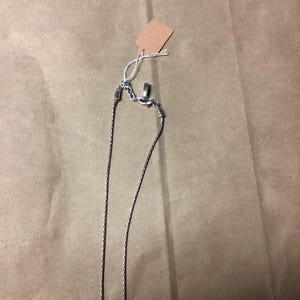 May include: A silver chain necklace with a clasp fastening. The chain is made of small, linked circles.