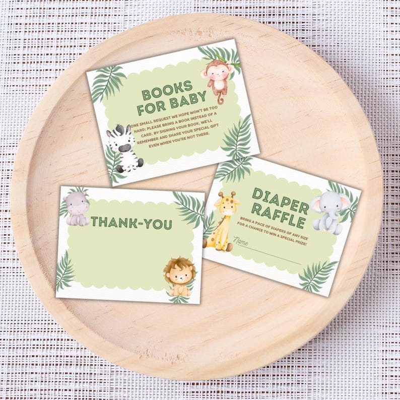 May include: Three baby shower cards featuring jungle animal illustrations. The cards are light green with scalloped edges and tropical leaf accents. Text on the cards reads "Books for Baby", "Thank-You", and "Diaper Raffle".