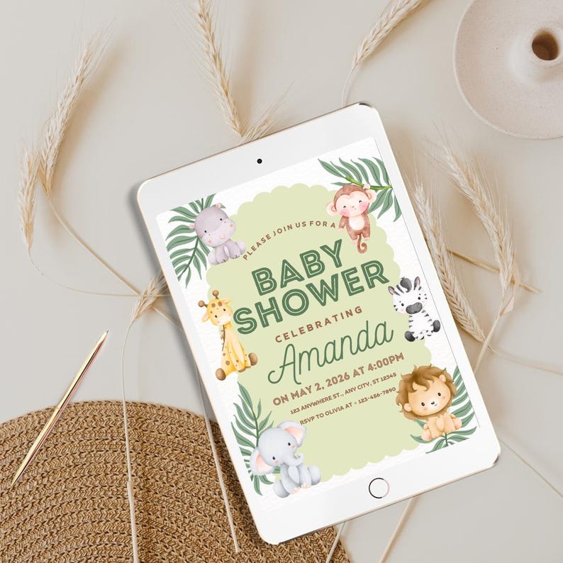 May include: A digital tablet shows a baby shower invitation. The invitation has a light green background with jungle animal illustrations, including a giraffe, zebra, lion, elephant, monkey, and hippo. Text reads "Baby Shower Celebrating Amanda".