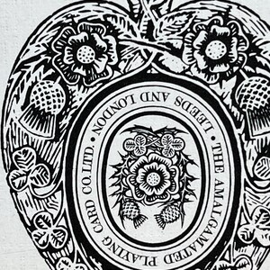 May include: Black and white illustration of a heart-shaped design with floral and leaf motifs. The text "THE AMALGAMATED PLAYING CARD CO. LTD. LEEDS AND LONDON" is visible within the design. The image has a vintage aesthetic.
