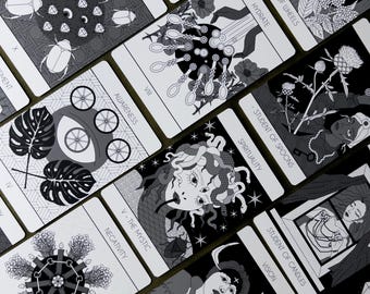 May include: Black and white illustrations of tarot cards with various symbols and designs. The cards feature titles such as "Ace of Wheels", "Student of Spoons", and "The Mystic".