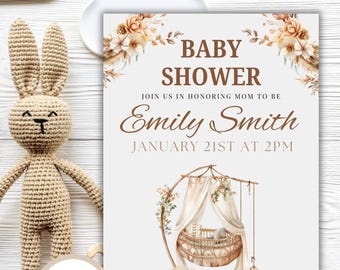 May include: A baby shower invitation with a boho theme. The invitation features a watercolor illustration of a cradle with a floral garland. The text reads "Baby Shower" and "Join us in honoring Mom to be Emily Smith January 21st at 2PM".