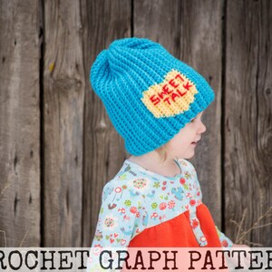May include: A blue crocheted hat with a yellow and red applique that says "Sweet Talk". The hat is being worn by a child.