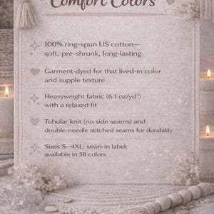 May include: A light-colored informational card with the text "Comfort Colors" and product details. The card lists features like 100% ring-spun US cotton, garment-dyed fabric, and heavyweight fabric. The card is decorated with floral accents and a tassel.