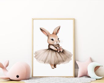 May include: Watercolor illustration of a bunny wearing a tutu and holding a pink bow. The bunny is light brown with long ears and a sweet expression. The tutu is a soft, muted brown color. The artwork is framed in a light wood frame.
