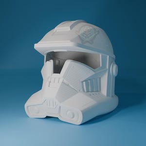 May include: A white plastic helmet with a visor and detailed design. The helmet has a textured surface and appears to be a prop or costume.