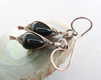 May include: A pair of black onyx teardrop earrings with copper wire wrapping and copper ear wires.