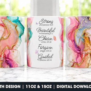 May include: A white ceramic mug featuring an abstract watercolor design in shades of pink, teal, and gold. The center displays the text: Strong Philippians 4:13, Beautiful Ecclesiastes 3:11, Chosen John 15:16, Forgiven Psalm 103:12, and Guided Psalms 48:14.
