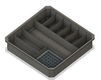 Puede incluir: Un organizador de plástico gris con múltiples compartimentos. El organizador tiene una sección en forma de cuadrícula en la esquina inferior derecha.