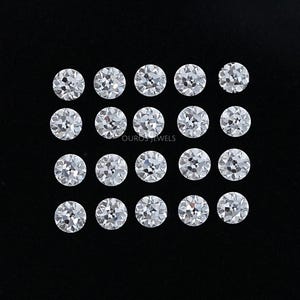 May include: Twenty-one round, brilliant-cut diamonds arranged in a grid pattern on a black surface. The diamonds are clear and sparkling, reflecting light. The image is a close-up shot, highlighting the facets and clarity of the gemstones. The background is a dark, solid color.