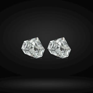 May include: Two loose, colorless, pentagon-shaped faceted gemstones with a brilliant cut. Each stone features a symmetrical arrangement of triangular and trapezoidal facets that reflect light. The text OUROS JEWELS is printed in small white letters below each stone.