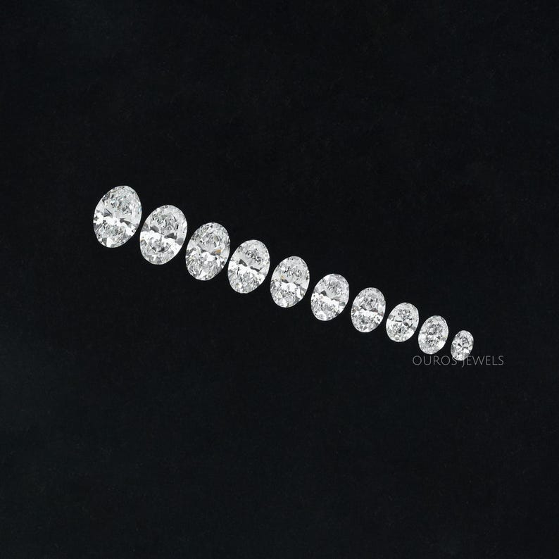 May include: A row of oval-shaped diamonds of varying sizes, arranged in a graduated pattern on a black background.