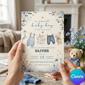 May include: A baby shower invitation card featuring a watercolour design with blue floral accents, a clothesline with baby clothes, and a teddy bear. The text reads: a sweet baby boy is on his way! Oliver, January 15, 10:00am, 8843 Flower Avenue.