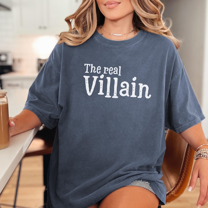 Embrace your inner mischief with our Comfort Colors T-shirt featuring The  real Villain printed boldly across the chest.