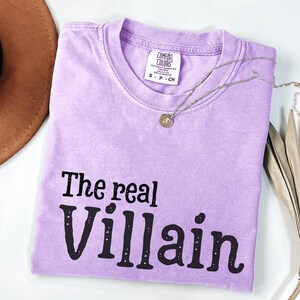 Embrace your inner mischief with our Comfort Colors T-shirt featuring The Villain printed boldly across the chest.