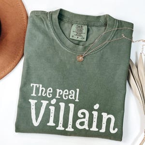 Embrace your inner mischief with our Comfort Colors T-shirt featuring The Villain printed boldly across the chest.