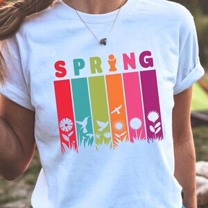 Colorful spring graphic tee featuring flowers, birds, and nature-inspired art. Cute camping shirt for women, ideal for spring hiking, outdoor adventures, and casual wear.