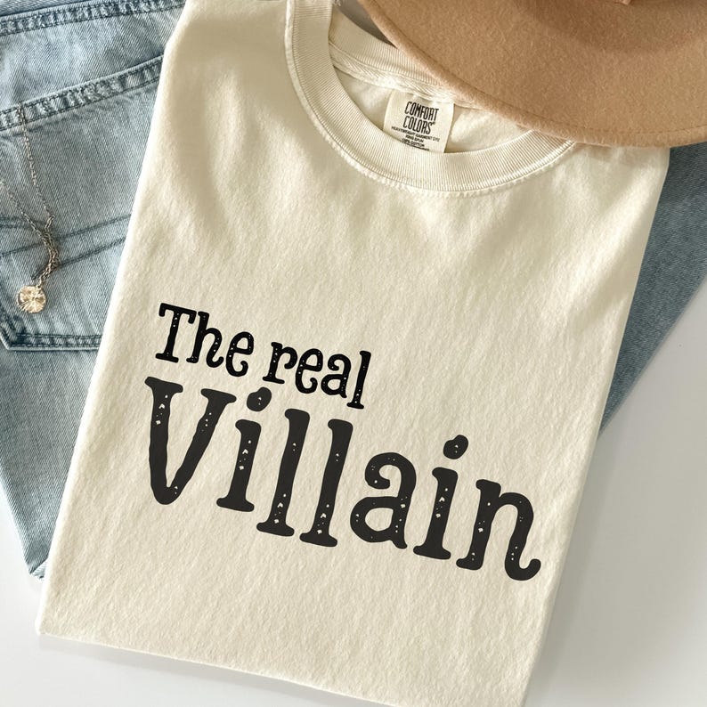 Embrace your inner mischief with our Comfort Colors T-shirt featuring The Villain printed boldly across the chest.