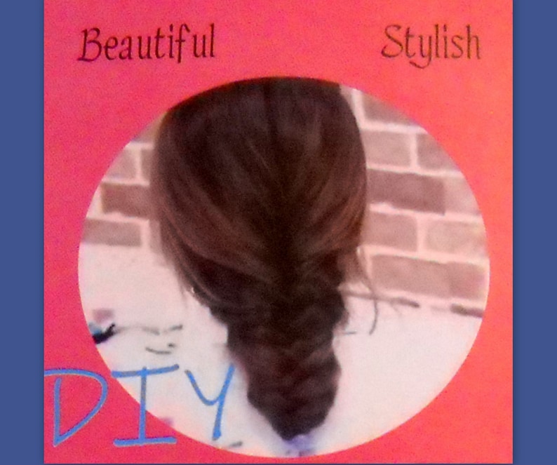May include: A fishtail braid hairstyle, framed by a pink border with the words "Beautiful" and "Stylish" at the top and "DIY" at the bottom. The background is a brick wall.
