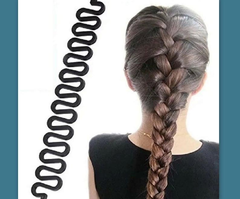 May include: A black hair braiding tool with a wavy design is shown next to a person's braided hair. The hair is a mix of brown and blonde shades. The tool is designed to help create intricate braided hairstyles.