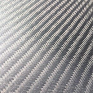 May include: A close-up of a black carbon fiber material with a woven pattern.