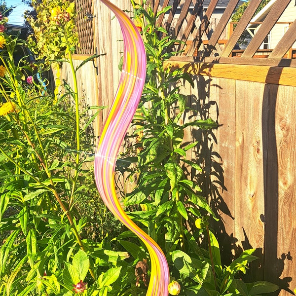 Hand blown glass wave ribbon, purple with yellow highlights.