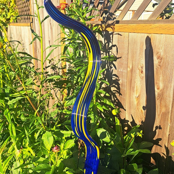 Blown glass garden art ribbon blue and orange accent.