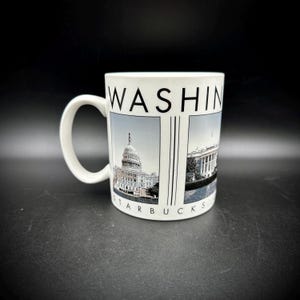 May include: White ceramic mug featuring the word "WASHINGTON" at the top. The mug has two panels with images of the U.S. Capitol Building and the White House. The word "STARBUCKS" is printed at the bottom of the mug.