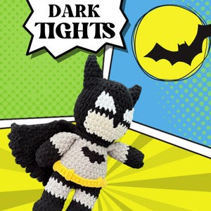 May include: A handmade crochet Batman doll with a black cape, gray body, and yellow belt. The background features a comic book style design with the words "DARK TIGHTS" in a speech bubble and a yellow moon with a bat silhouette.
