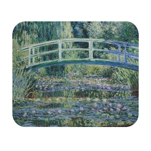 May include: Mousepad featuring a print of Claude Monet's "Water Lilies and Japanese Bridge." The artwork depicts a serene pond with water lilies and a green bridge, surrounded by lush greenery. The color palette includes blues, greens, and purples.