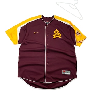 May include: Maroon baseball jersey with gold and white accents. Features a large gold "A" logo on the chest and a Nike swoosh. The jersey has a button-up front and short sleeves. A white hanger is in the background.