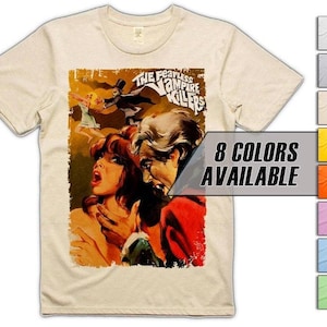May include: A cream-coloured t-shirt with a vintage movie poster design. The poster art shows a man and woman, with the text "THE FEARLESS VAMPIRE KILLERS". The shirt also displays "8 COLORS AVAILABLE".
