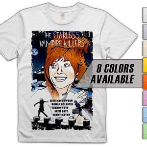 May include: White t-shirt with a movie poster design for "The Fearless Vampire Killers." The graphic includes a woman's portrait, the film's title, cast names, and the text "8 Colours Available."