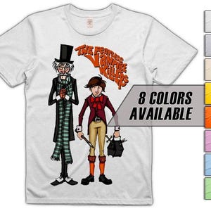 May include: White t-shirt with a cartoon illustration of two characters from "The Fearless Vampire Killers." The design includes the text "The Fearless Vampire Killers" in orange. The shirt also displays "8 COLORS AVAILABLE" in a gray box with colour swatches.